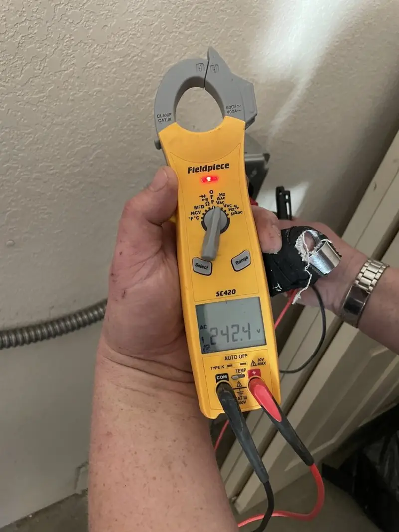 Voltage testing with clamp meter during Electrical Installation Services in Clermont